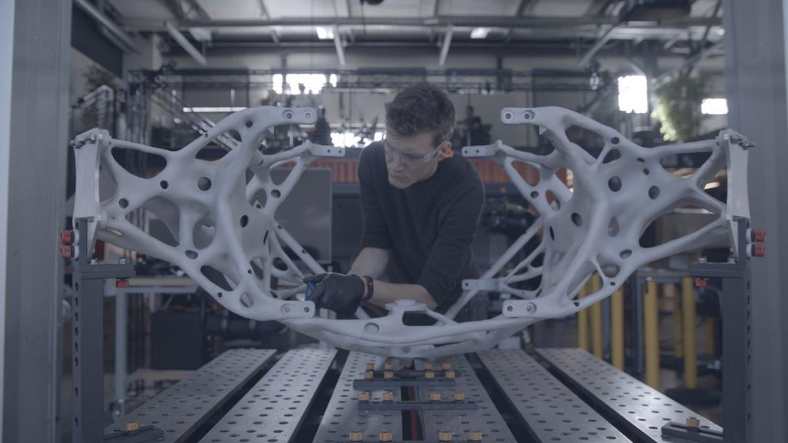 a man working on a piece of white plastic